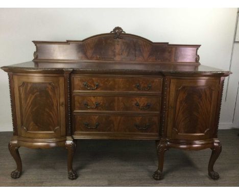 MAHOGANY SIDEBOARD OF CHIPPENDALE DESIGN,with raised gallery back above three short drawers flanked by cupboard doors, on cab