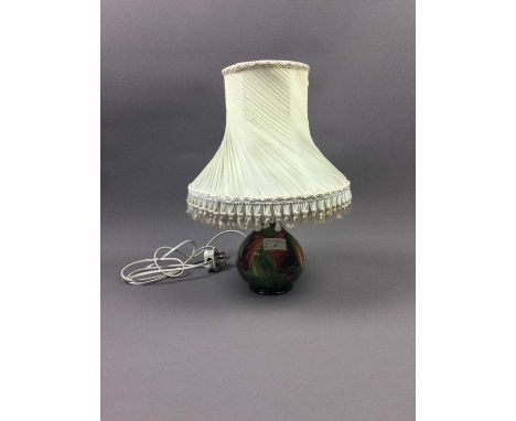 MOORCROFT TABLE LAMP,decorated with stylised leaves and berries, 16cm high, with a fringed shade