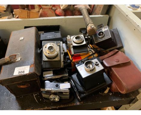 Part shelf of cameras to include Polaroid, boxed Kodak Cine etc condition requests and additional images will not be given fo