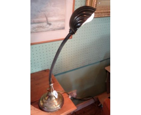 An early/mid-20th century brass flexible desk lamp, having stylized shell like shade on circular base (57cm).