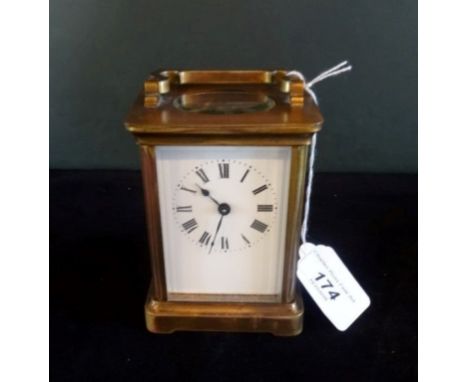 A French gilt brass carriage clock, the movement signed R & Co., Paris, five panelled bevel edged glass, the enamel dial bear