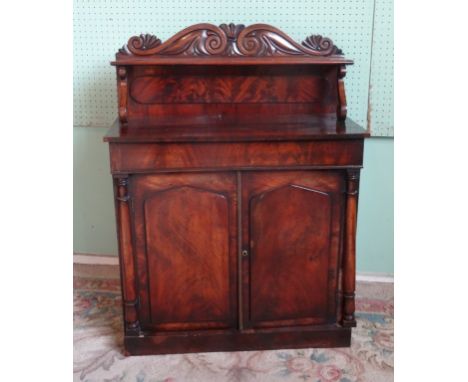 A Victorian mahogany chiffonier, the upper shelf supported my scroll mounts over two cupboard doors (91cm wide). Condition Re