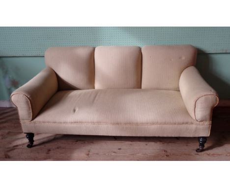 A Victorian three seater sofa, on turned ebonised supports (177cm wide).