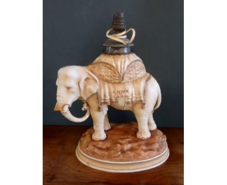 A late 19th century Alfred Stellmacher Turn Teplitz porcelain oil lamp in the form of an Indian elephant, with gilded decorat