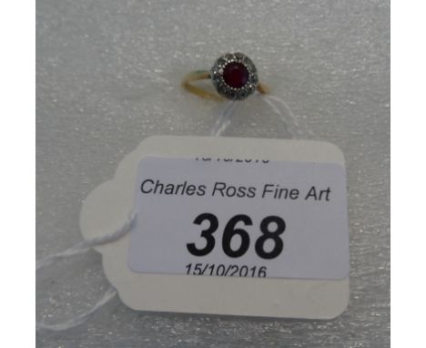 A ruby and diamond cluster ring, the circular cut ruby within a border of single cut diamonds to plain shank.