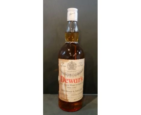 A bottle of Dewar's Finest Scotch Whisky, White Label, bottled in the 1970's, 26 2/3rds fl oz, 70% proof.