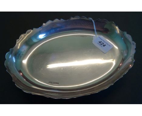 An oval silver dish on four outswept supports, Sheffield hallmarks 1945, 10 troy ounces.