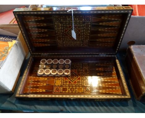 An inlaid folding games box, having chess board to the top, backgammon to the interior, together with a set of unopened match