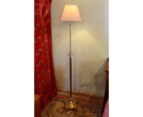 A brass extending standard lamp, the corinthian-style column over stepped square base on pad feet.