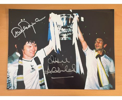 Football. Tottenham Hotspurs FC Steve Perryman and Ossie Ardiles Signed 16x12 colour photo. Photo shows the pair holding a tr