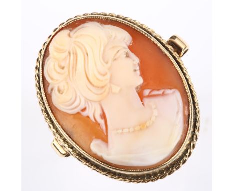 A large 9ct gold shell cameo ring, depicting female profile, setting height 32.8mm, size Q/R, 10.4g 