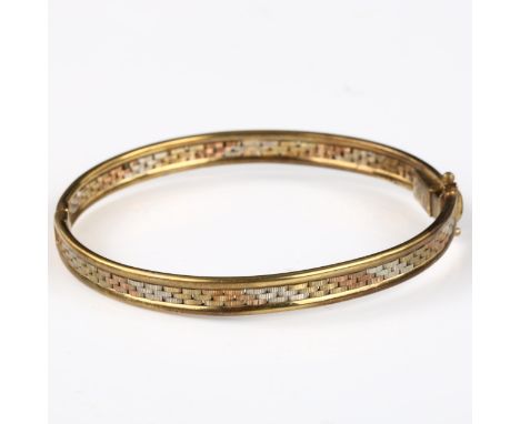 A 9ct three-colour gold hinged bangle, band width 6mm, internal diameter 5cm, 10.4g 
