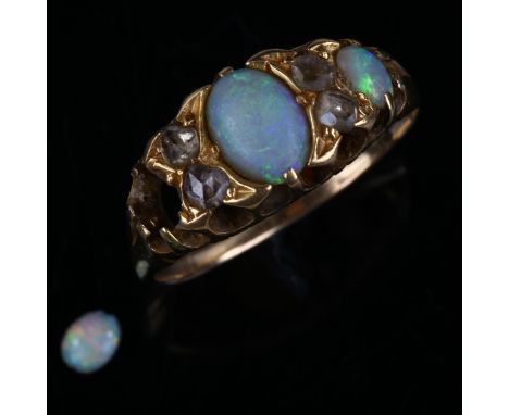 An early 20th century seven stone opal and diamond half hoop ring, unmarked gold settings with oval cabochon opal and rose-cu