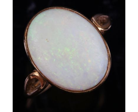 A modern 9ct gold white opal dress ring, set with oval cabochon opal, setting height 16.9mm, size O, 4.1g 