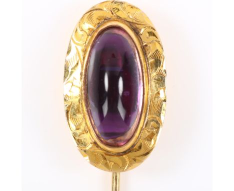 A 9ct gold cabochon amethyst stick pin, bright-cut engraved foliate surround with oval cabochon, stick pin head length 21.4mm