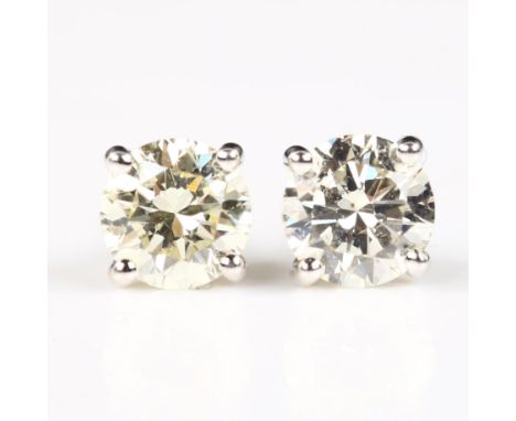 A pair of 18ct white gold 1.01ct solitaire diamond stud earrings, plain 4-claw setting with modern round brilliant-cut diamon