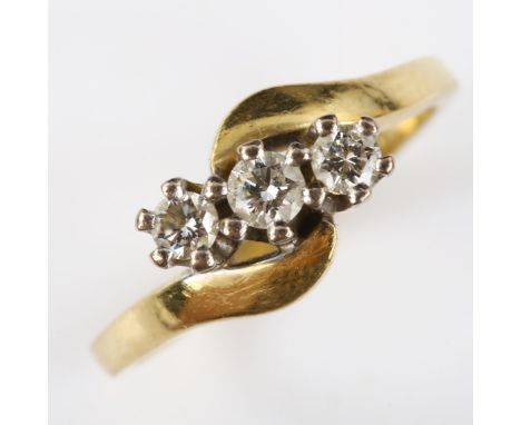 A modern 18ct gold three stone diamond crossover ring, set with modern round brilliant-cut diamonds, total diamond content ap