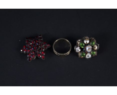 Three pieces of antique jewellery including gold band ring with engraved initials, a garnet set star shaped brooch and a whit