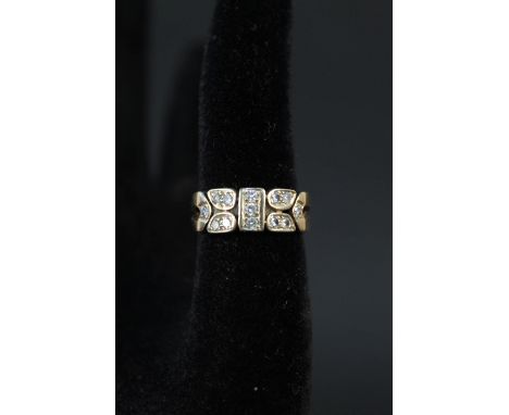 A 9ct gold ring with unusual panel design set with diamonds, size R