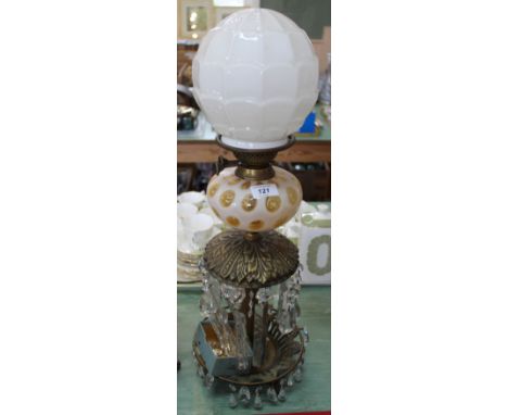 A brass droplet oil lamp with yellow and white glass bowl plus a glass shade