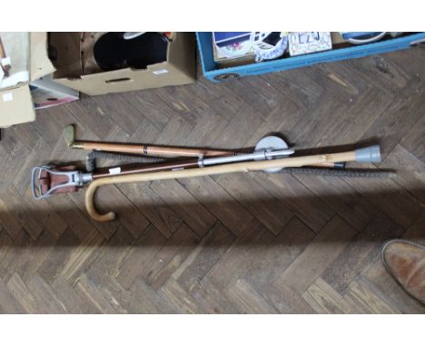 A shooting stick plus three walking sticks, one with brass golf club grip