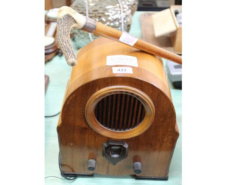 A walking cane with antler grip and silver band plus a retro mains radio (this item is sold as a collectors item only and has