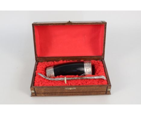 A boxed South American horn and white metal maté cup and spoon