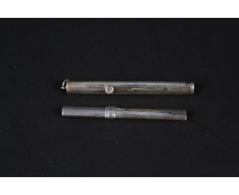 Two silver retractable toothpicks, one with engine turned decoration