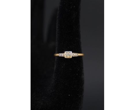 An 18ct gold ring set with a single diamond, size R