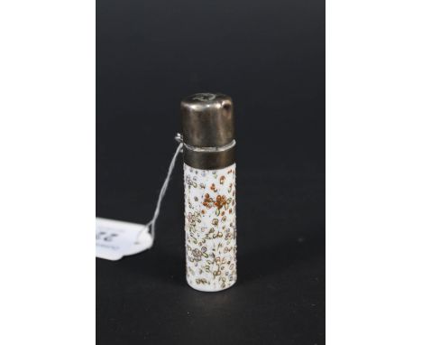A pretty scent bottle with ceramic body and white metal lid, the body has raised painted decoration of flowers