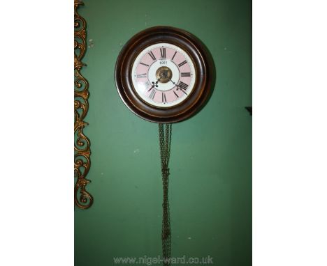 A Victorian wall alarm Clock, with pink face.