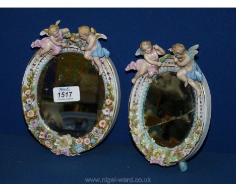 Two small Sitzendorf mirrors a/f, decorated with cherubs with garlands of flowers.