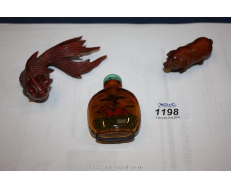 Two Netsuke items and an old bottle.