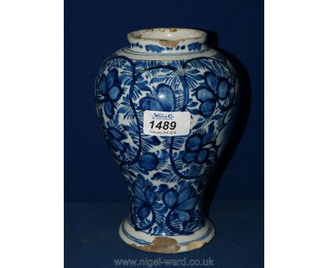 An 18th Century blue and white delftware baluster vase decorated with flowers, a/f.