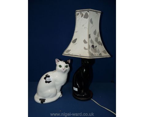 A black cat Lamp and shade and a large black and white pottery Cat with green glass eyes.