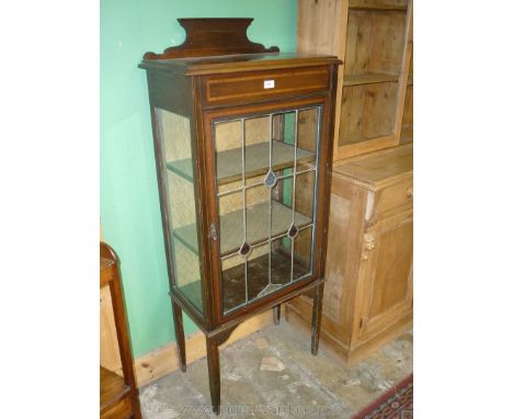 An early 20th c. Mahogany china display Cabinet having light and darkwood stringing and crossbanding, standing on square legs