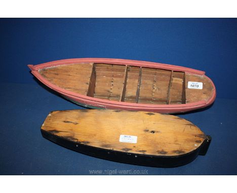 An old hand built model wooden boat hull, 52cm long and an old carved model Thames barge hull, 39cm long.