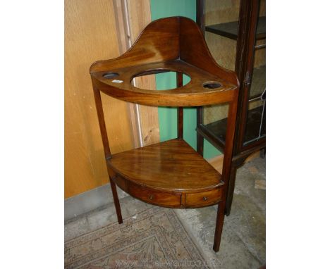 A Georgian Mahogany Corner Washstand having a top with upstand and three recesses, the lower shelf with a frieze drawer, 41''