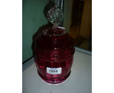 A Cranberry glass Biscuit jar with lid with twisted finial.