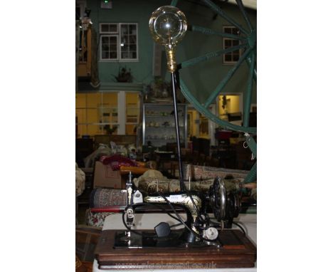 A Singer hand sewing Machine with additional sewing light