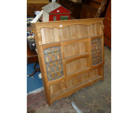 A light Oak matt finished floor standing Plate rack/Shelf unit incorporated a pair of opposing leaded glazed doored cabinet, 