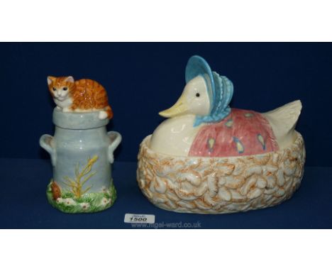 A Beatrix Potter milk churn/cat Tea Caddy along with a Beatrix Potter duck on well egg holder.