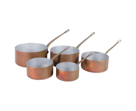 A graduated set of Vintage copper saucepans with brass handles, largest 20cm diameter 