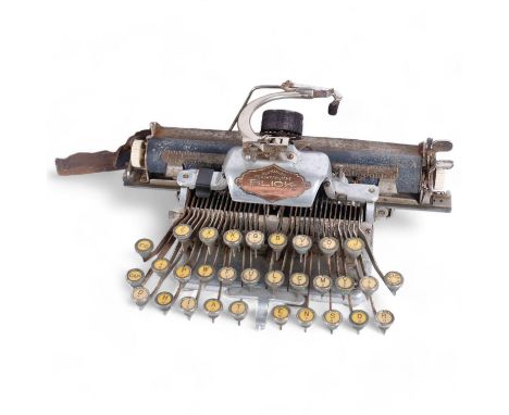 An early 20th century American Blick aluminium featherweight portable typewriter, in fitted stained oak case, cylinder 25cm 