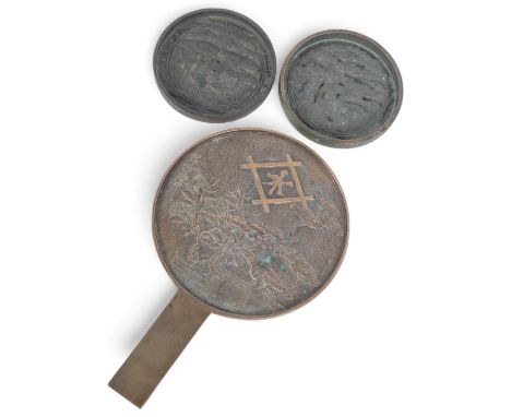 2 Chinese relief cast-bronze mirrors, and another similar hand mirror, 30cm (3) 