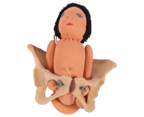 A vintage teaching aid, birthing demonstration, model includes baby and pelvis and detachable umbilical cord, and a plastic c