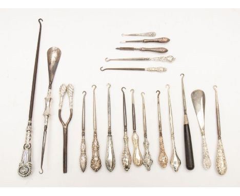 A collection of silver handled button hooks, shoe horns and other items, featuring a variety of Victorian and early 20th cent