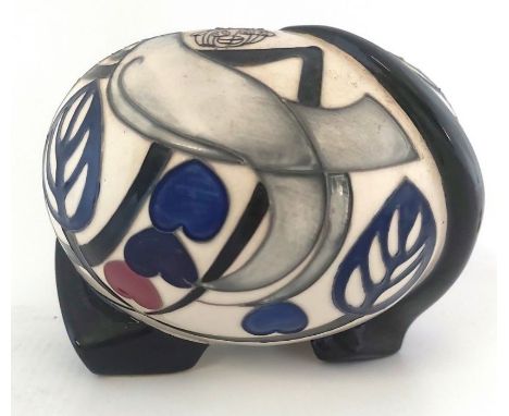 A Trial weather vane vase, it is decorated with a dove on each side and stylised open leaves, in blue and black glazed feet, 