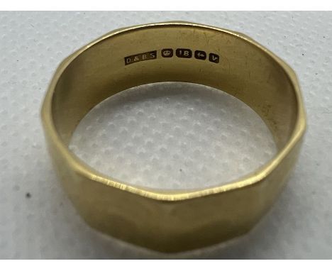 An 18ct gold geometric edged band ring. Size R. Gross weight approximately 6.5 grams.