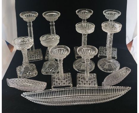 A group of press glass to include 5 pairs of tea light stands, tallest set 22cm tall, 3 pressed glass boats, 2 Gladstone pin 